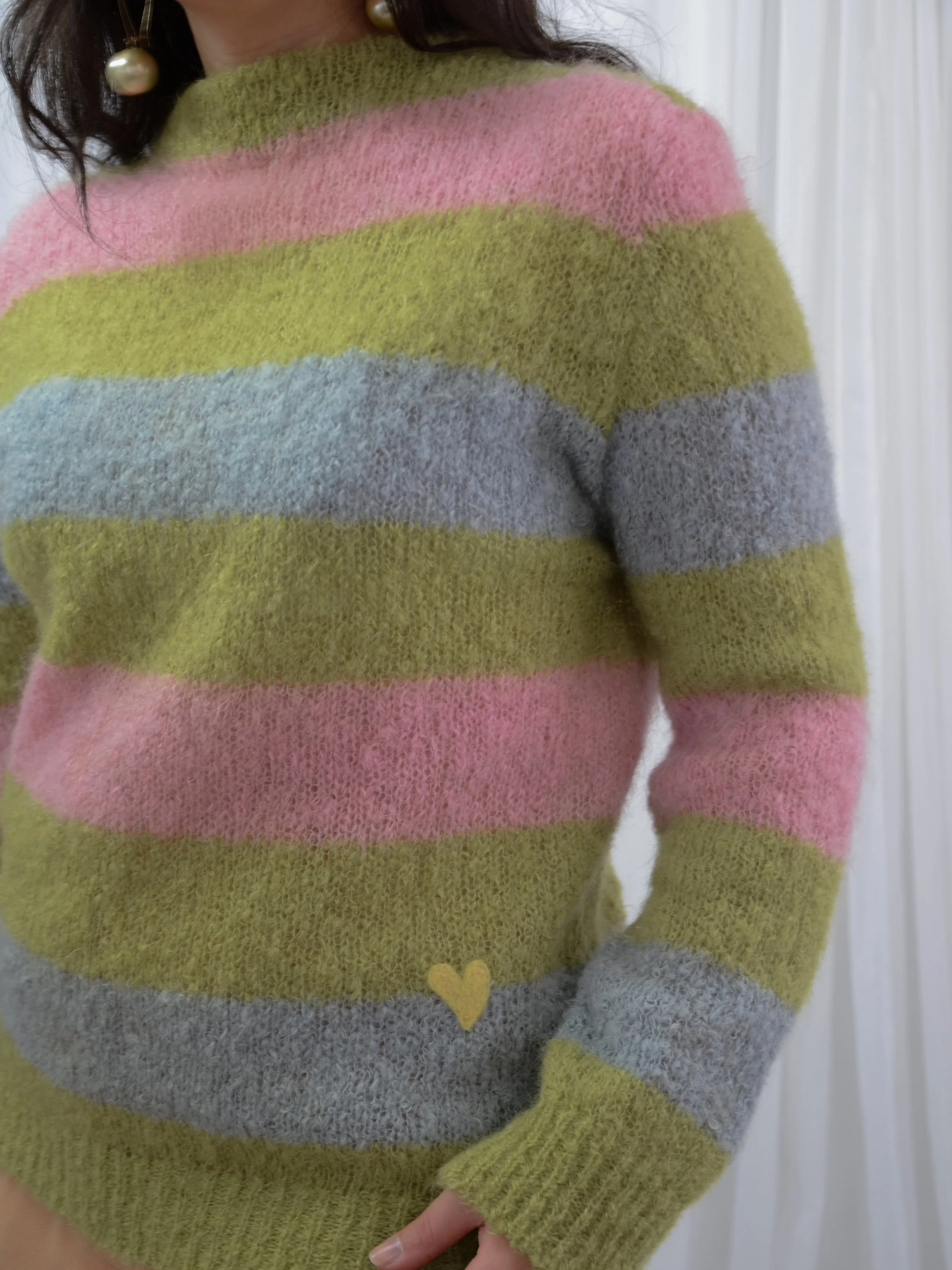 Close-up of the 1960s color block jumper, showing the small yellow felted heart on the hip.