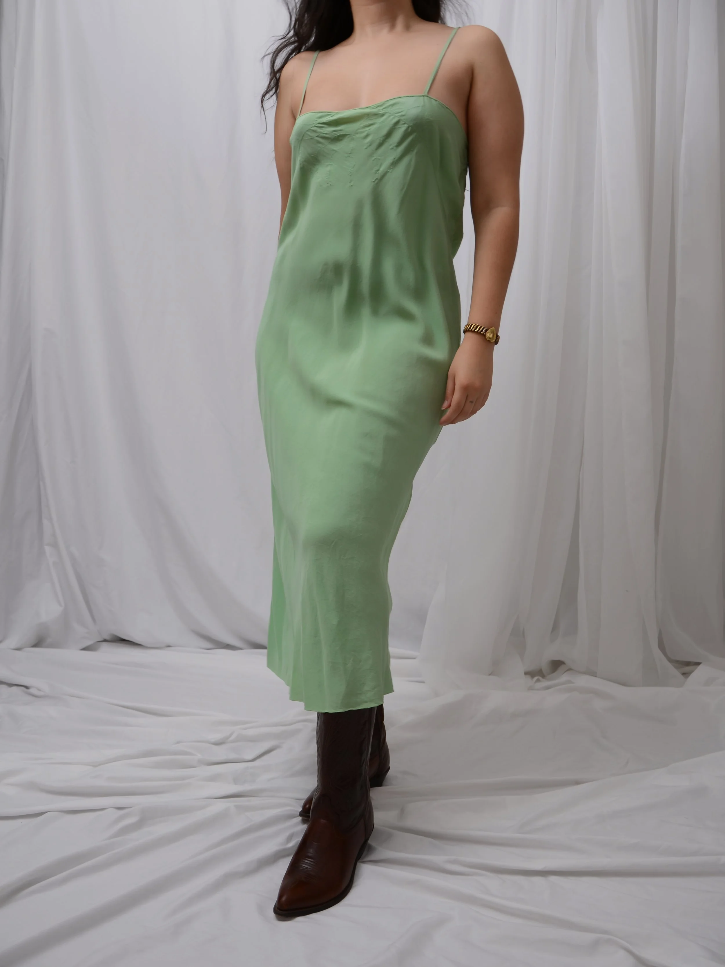 Front view of the late 1920s sage green silk slip dress on a model, showing the straight silhouette.