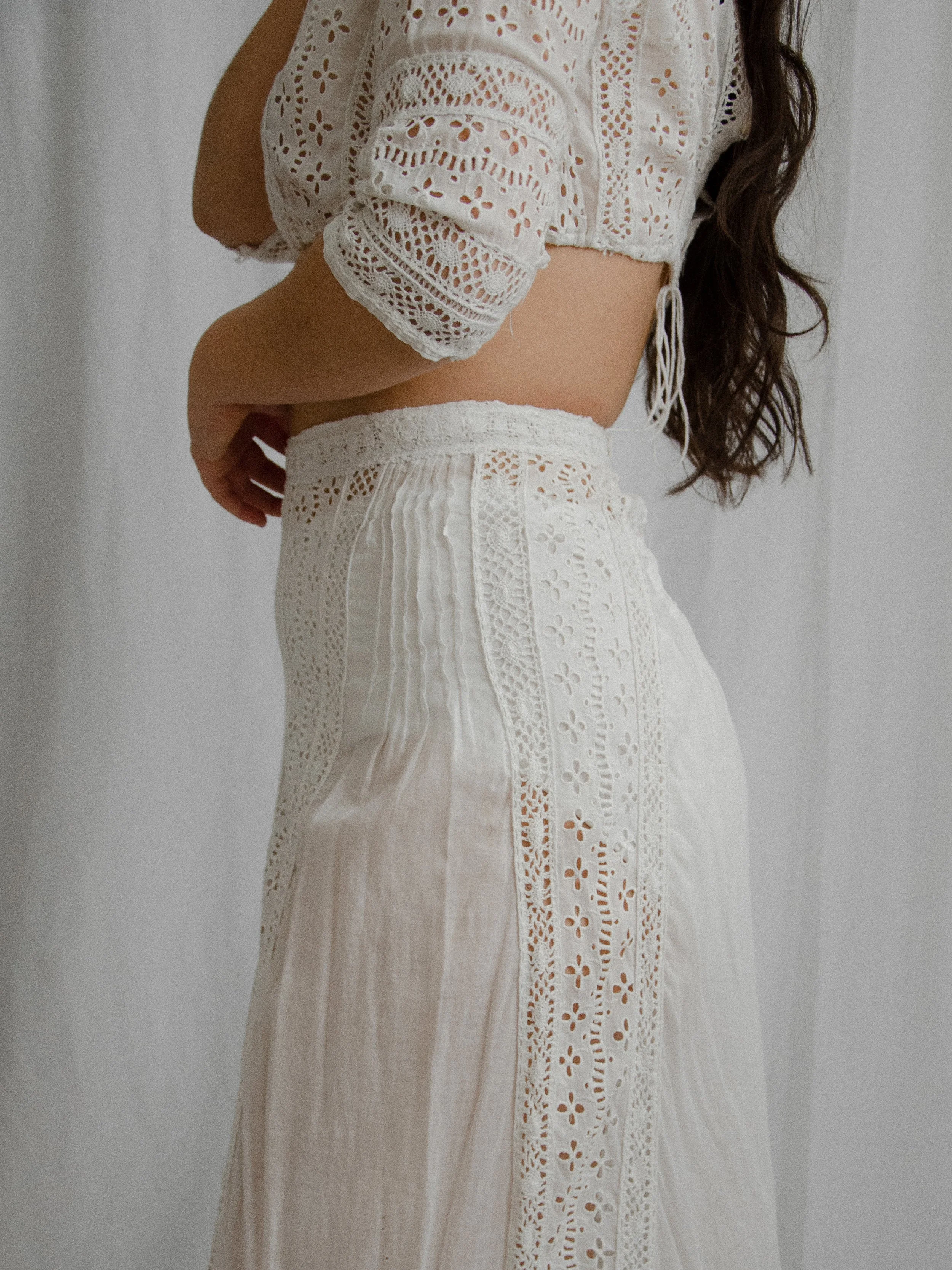 Side view of the Edwardian white cotton eyelet set on a model, showing the half sleeve and skirt.