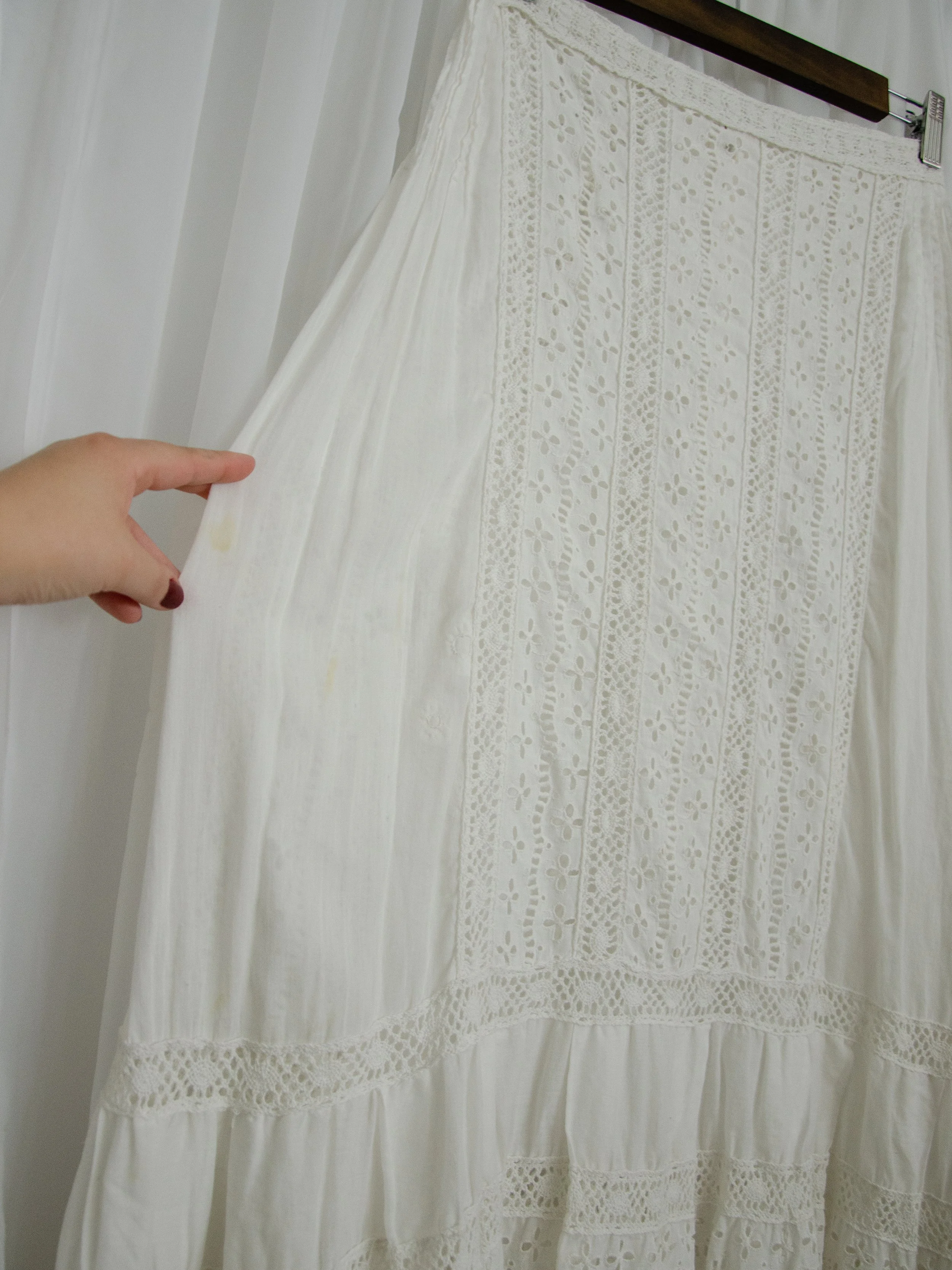 Close-up of the Edwardian eyelet skirt on a hanger, showing the eyelet front panel and lace band.