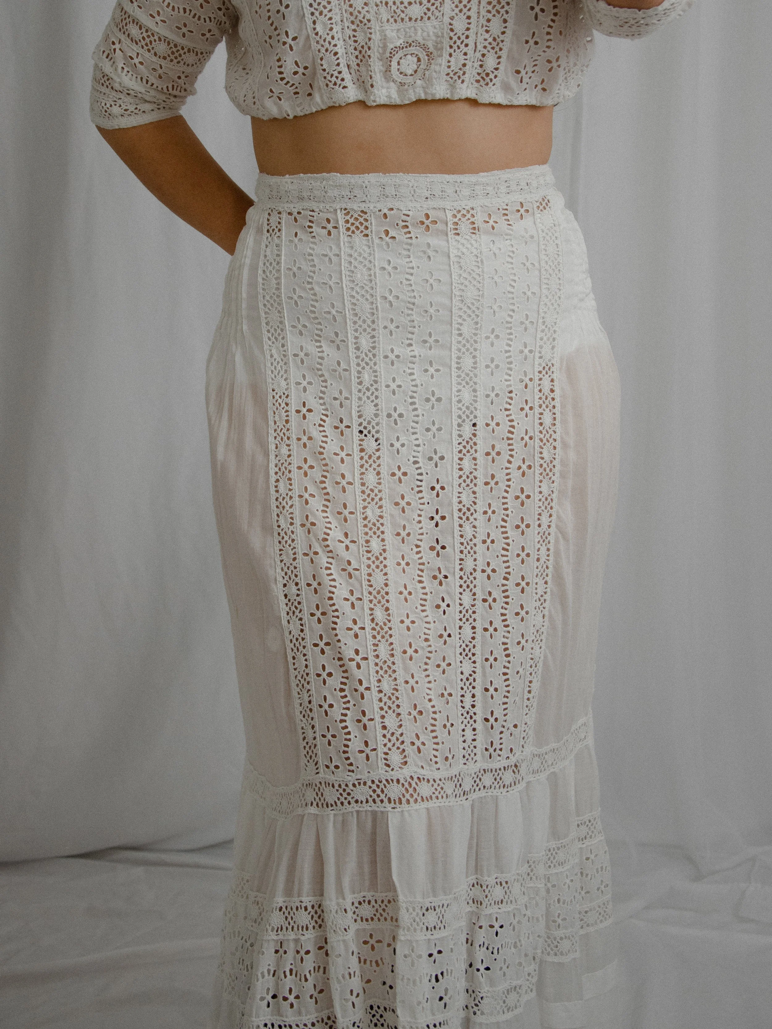 Front view of the Edwardian eyelet skirt and cropped top on a model, showing the fitted high waist.