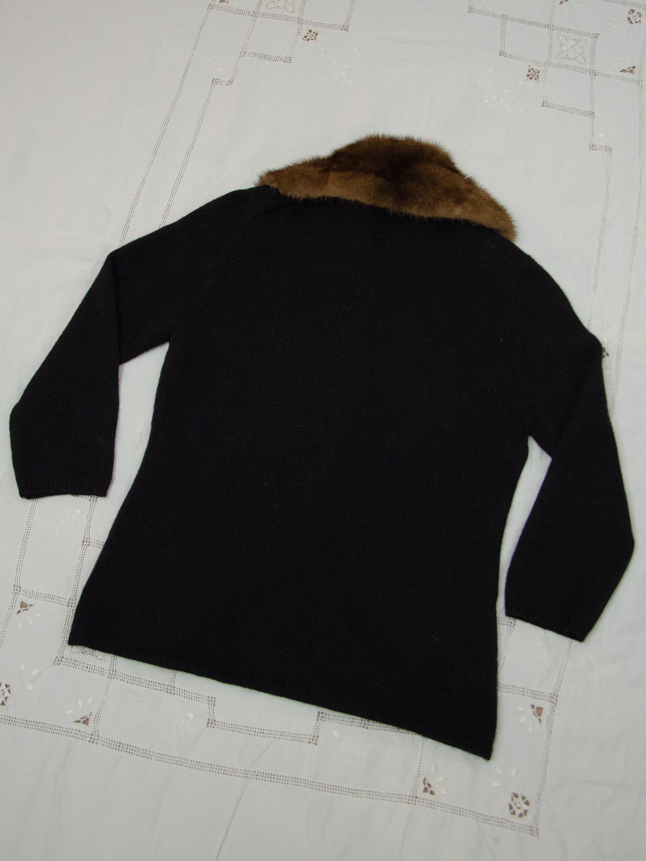 Back view of the 1940s black knit cardigan laid flat, showing the brown mink fur collar.