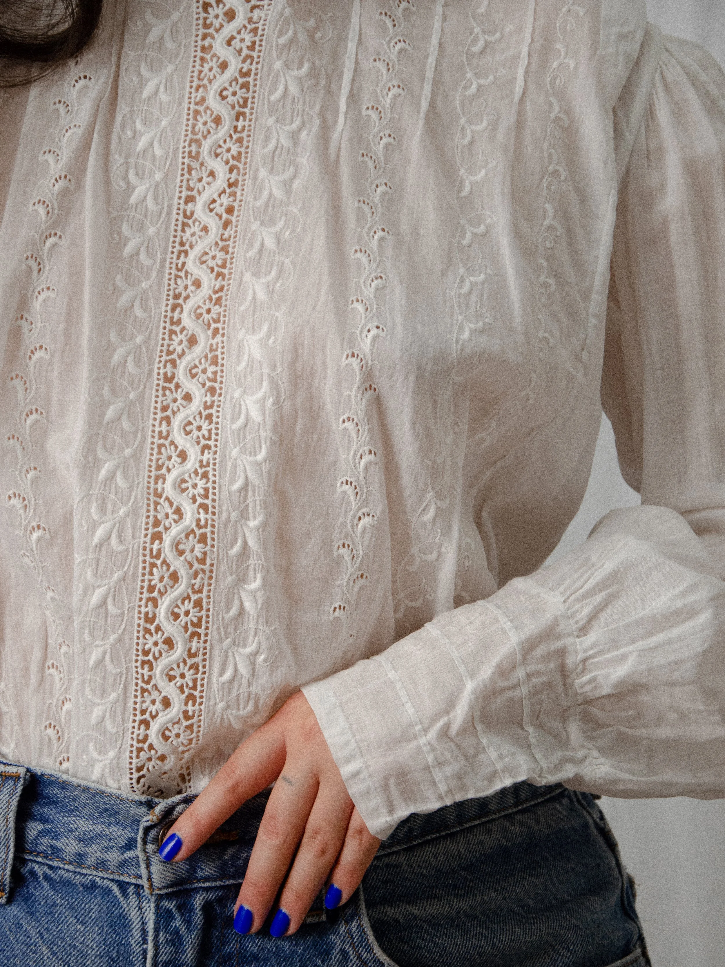 Close-up of the Edwardian white cotton top's front, showing the vertical lace insert and floral whitework.