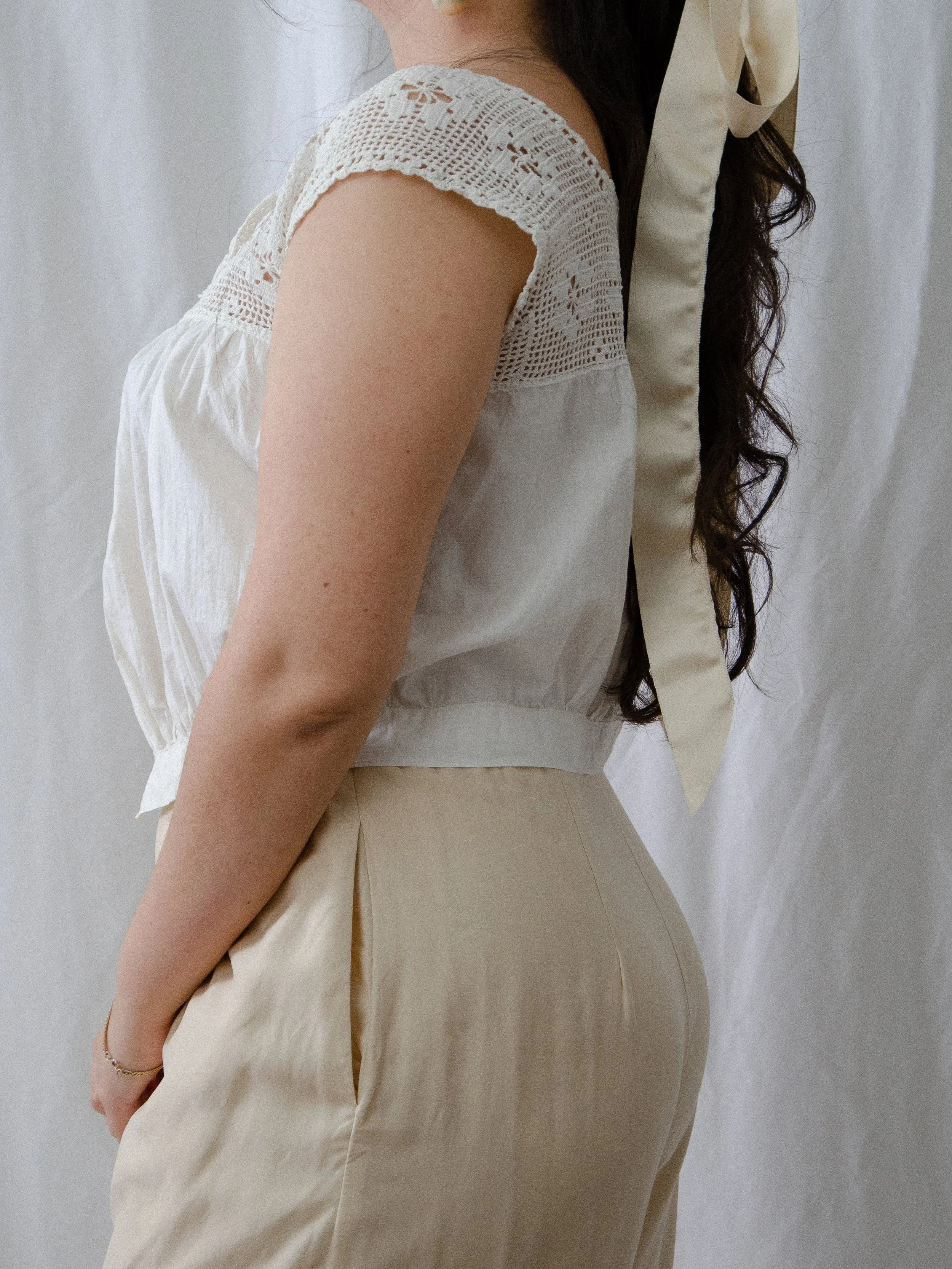 Side view of the antique crochet tank on a model, showing the crochet cap sleeve and gathered body.