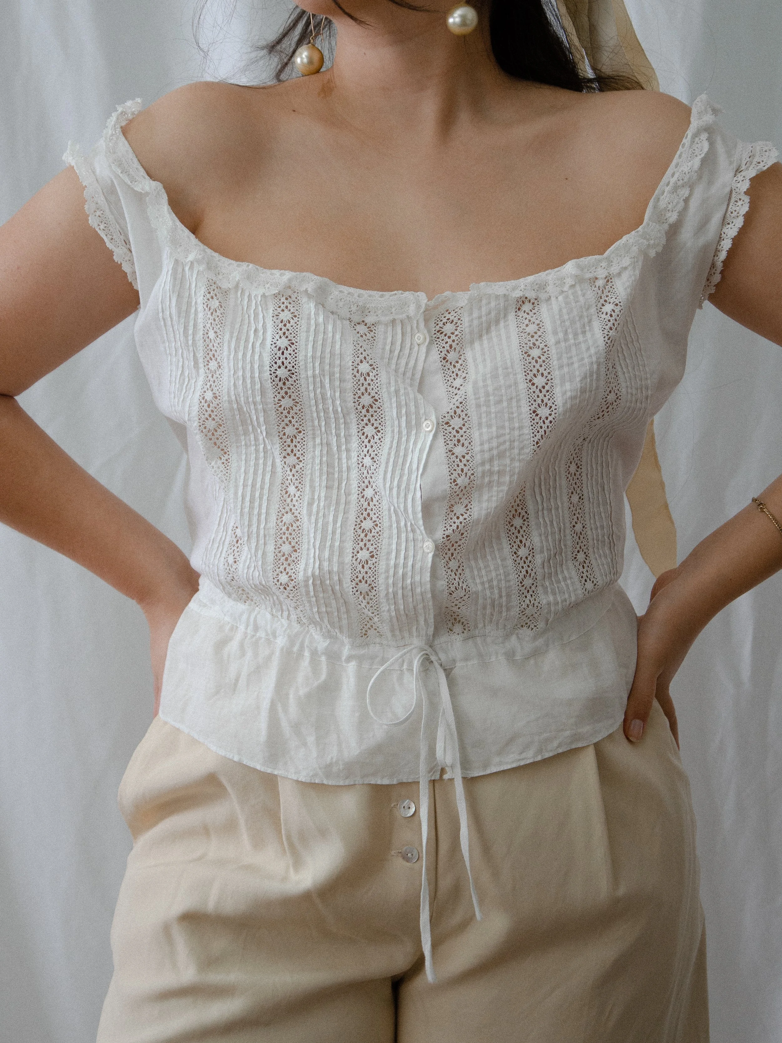 Front view of the 1900s-1910s white cotton corset cover on a model, showing the drawstring waist.