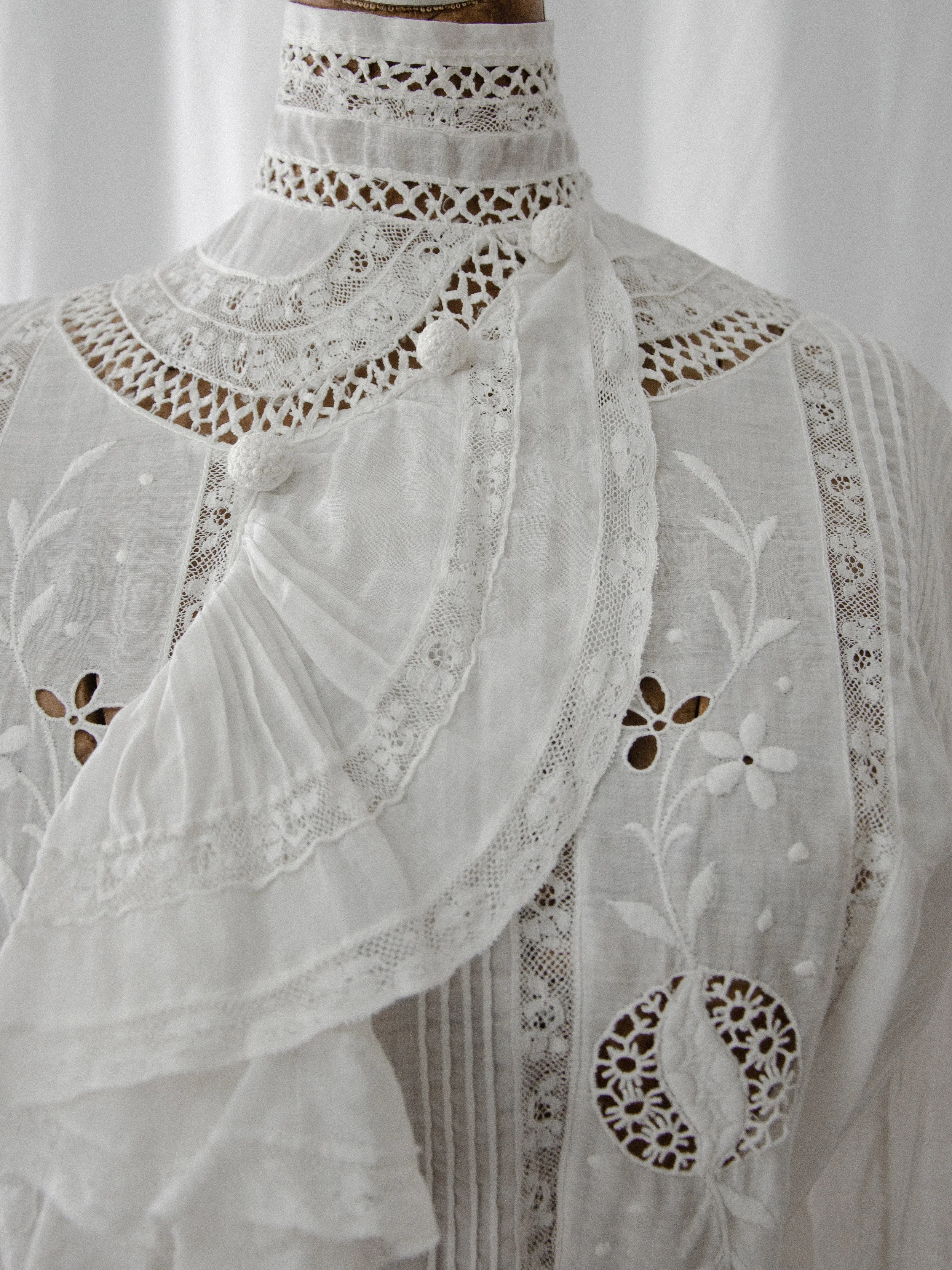 Detail of the Edwardian ascot blouse's lace yoke, ruffled ascot and embroidered cutwork medallion.