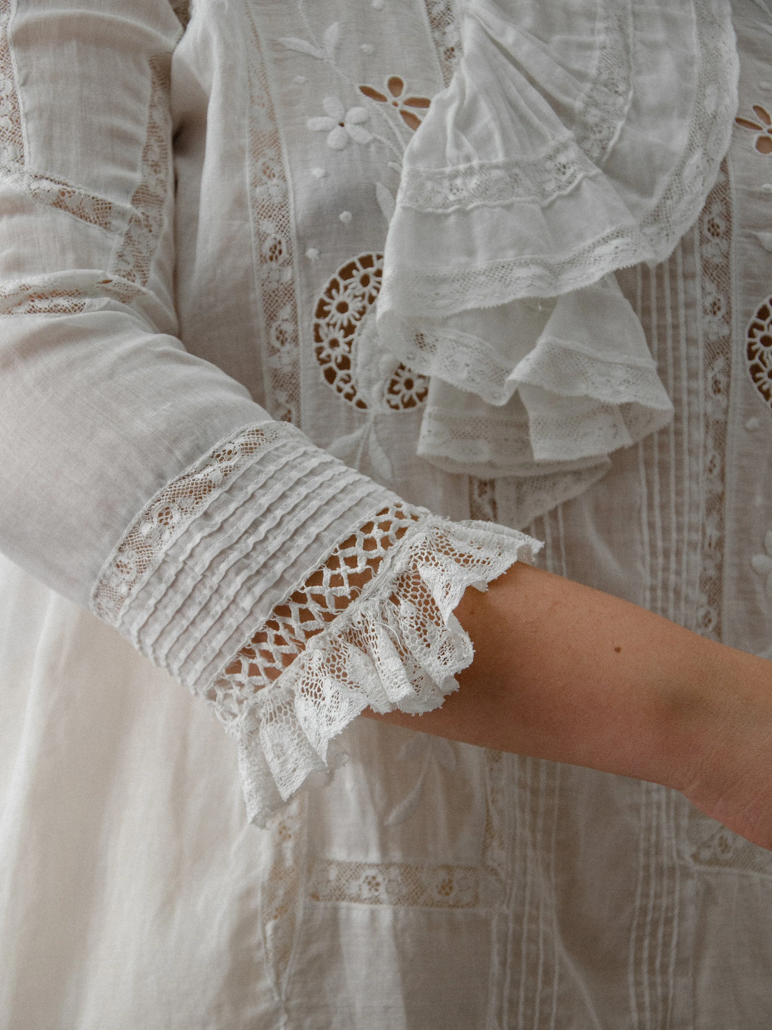 Detail of the Edwardian ascot blouse's pintucked sleeve with lace cuff and ruffled jabot.
