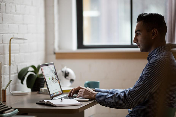 Man shopping online at his desk.