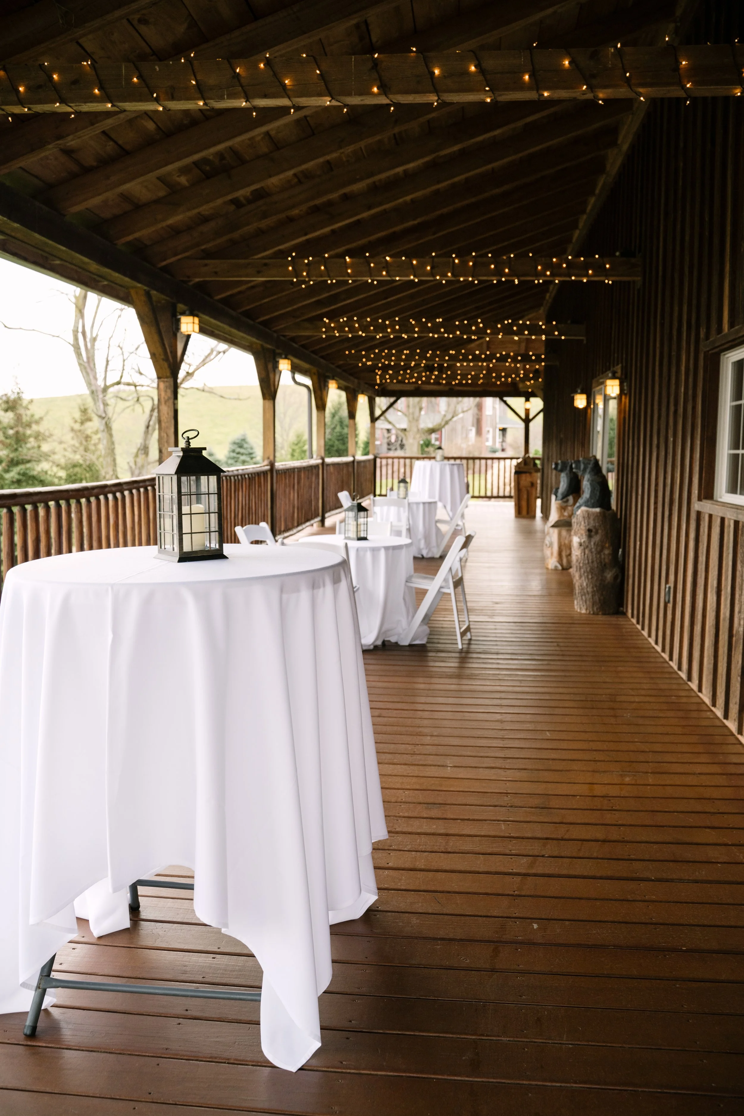 Armstrong Farms Fieldstone barn wedding venue wraparound deck with cocktail tables