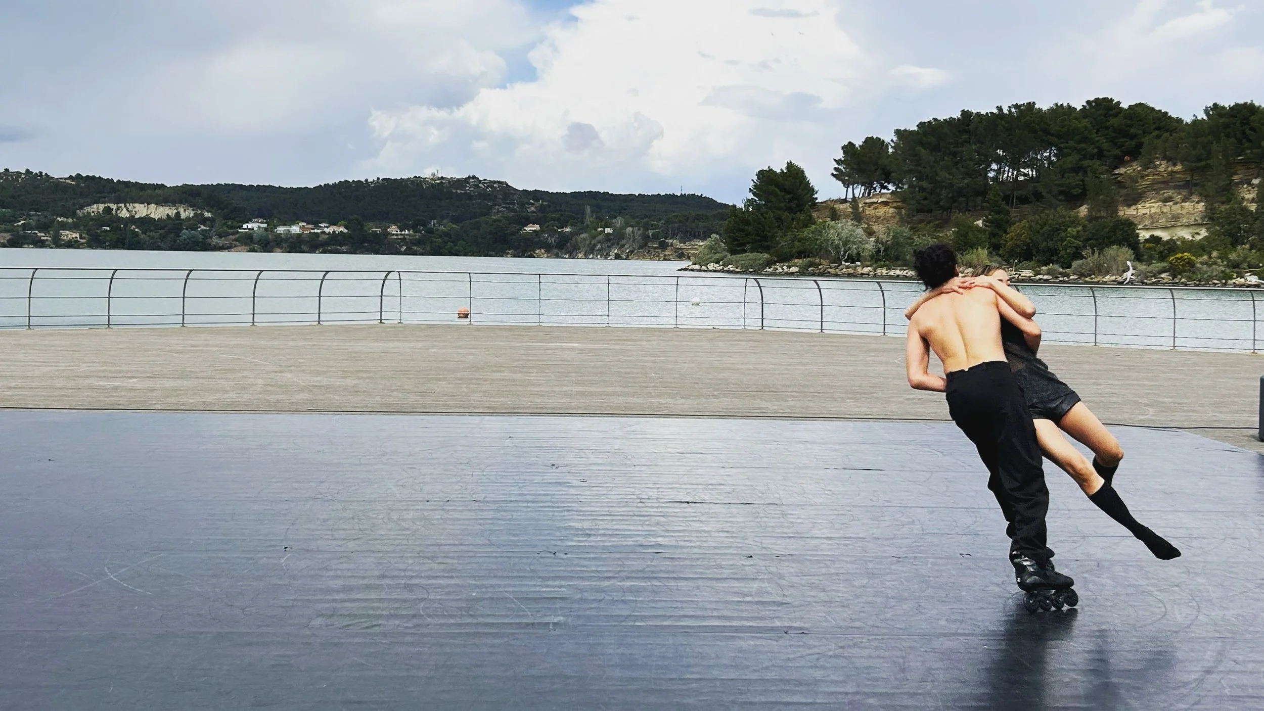 Two dancers on in line roller skates performing Reflet (Reflection).