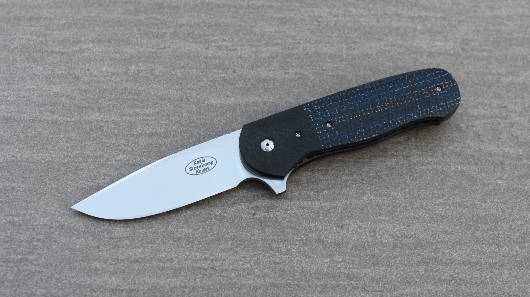 Knife: Vantage Flipper Liner Lock - IKBS. Böhler N690 Stainless Steel blade. Titanium liners with blue LSCF + black CF handle scales. Titanium belt clip.