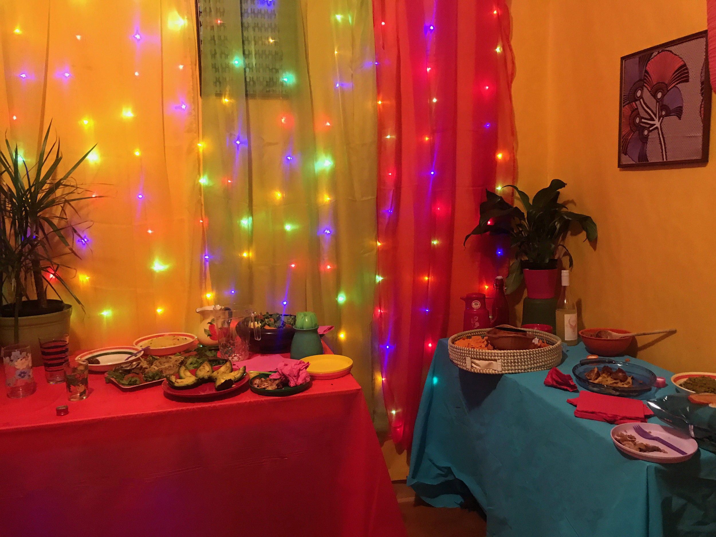The party scene pushes the bold colors with lights and foods continuing the eclectic feel.