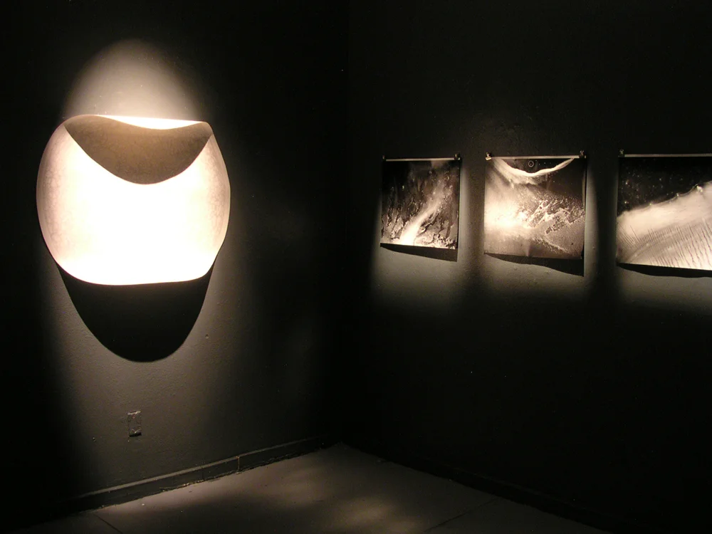 Installation view: glass plate ink drawings & Moon Map, School 33, 2005 The cliché verre drawings seen at right, and in the next two images were created through scanning and enlarging cropped sections of 4 x 5" ink drawings dried onto dusty glass plates. Portions of the digital scans were printed as large lamda prints. Other glass plates were used as negatives, printed with a photographic enlarger in the darkroom and developed as photographs. The resulting images resemble deep space photographs from NASA or satellite images, or of satellite images of planets.