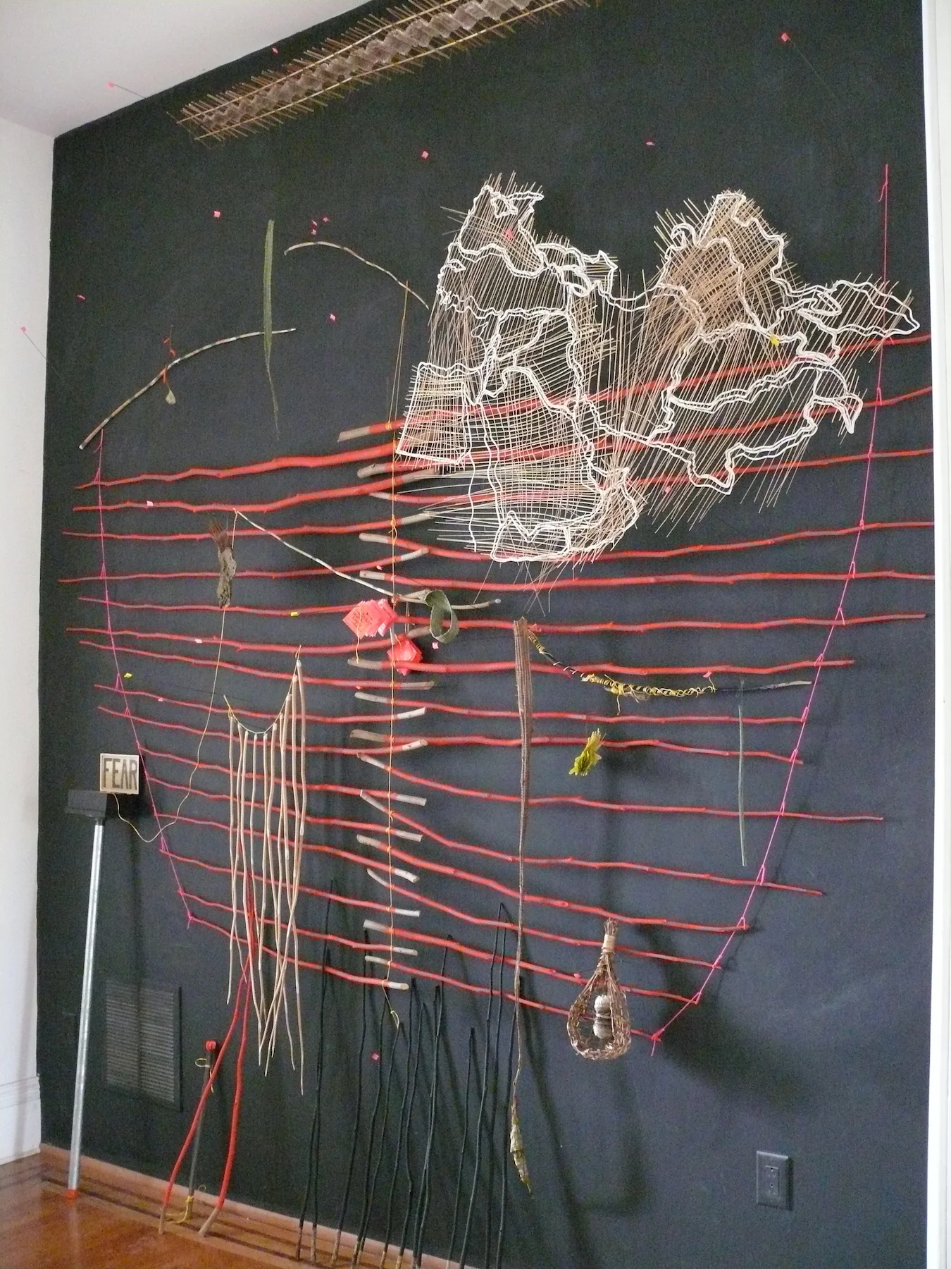   Territory: A Topographic Map  (with residue from ‘Black Box and Adjacent Body’) , 2017, grass, paper, painted sticks, flags, post, snake skin, string, bark, leaves, wood, thread,  dimensions &amp; materials variable  