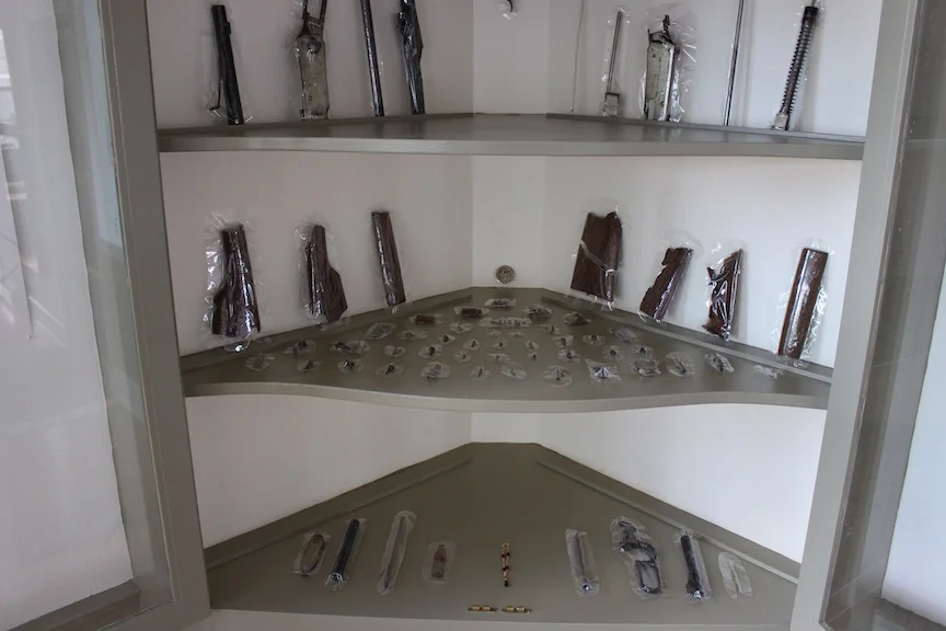 Detail: Disassembled Gun , 2016, packaged and set in China Hutch, Chestertown, MD for What Lies Beneath