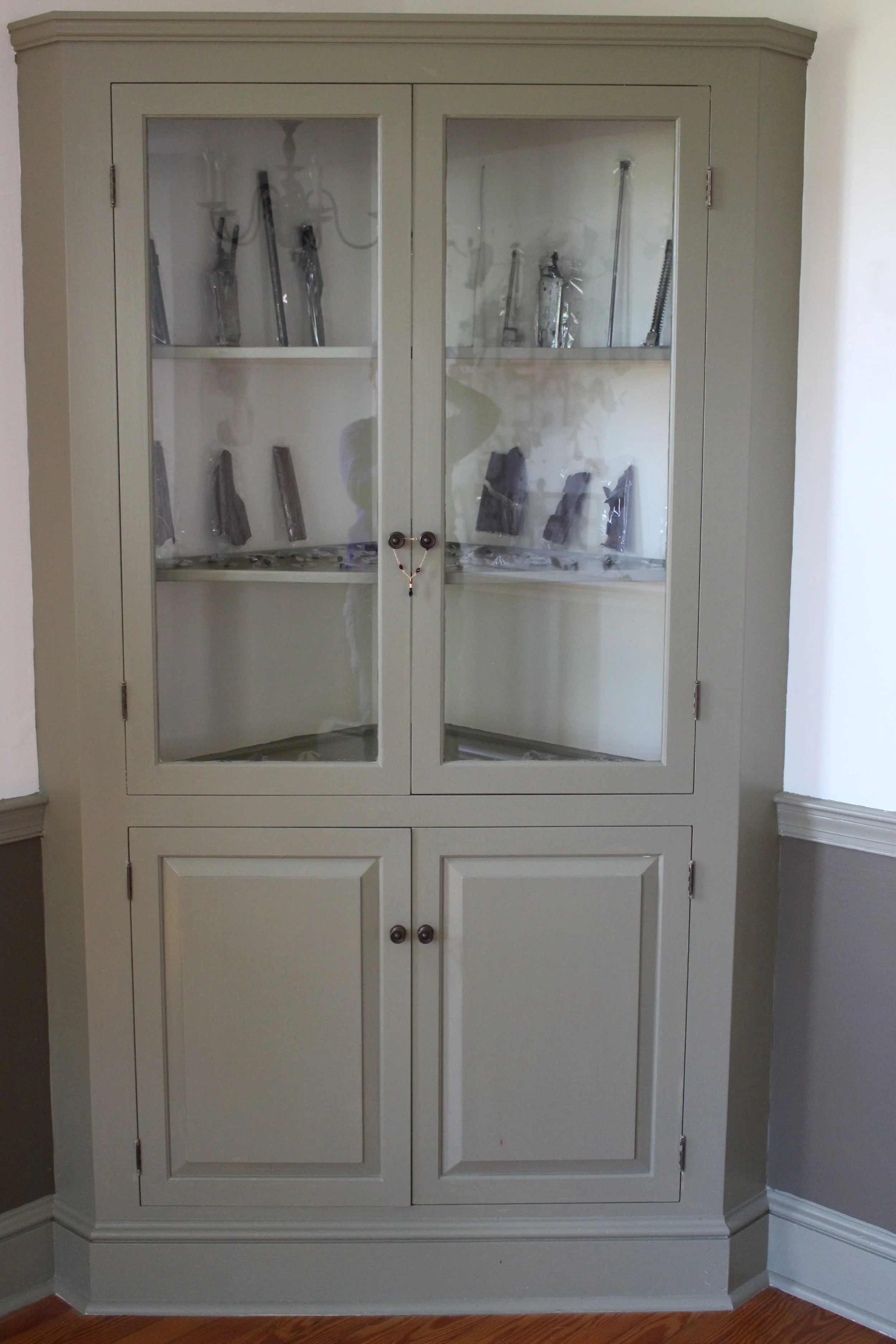 Installation view: Disassembled & Repackaged Gun in Hutch , from solo exhibit, What Lies Beneath at China Hutch, Chestertown, MD, 2017