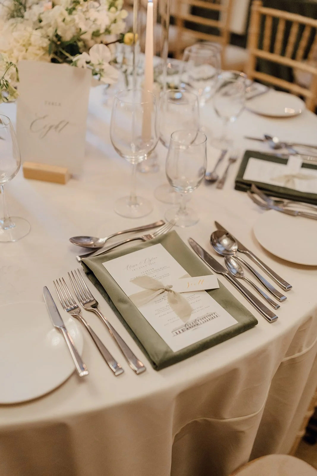 Ivory table setting with a green velvet menu card and table name at a Castlemartyr wedding