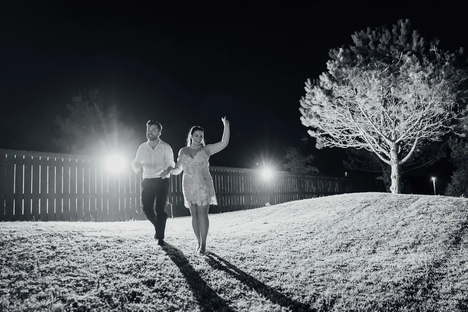 Bride and groom celebrating outdoors at night at their Castlemartyr wedding