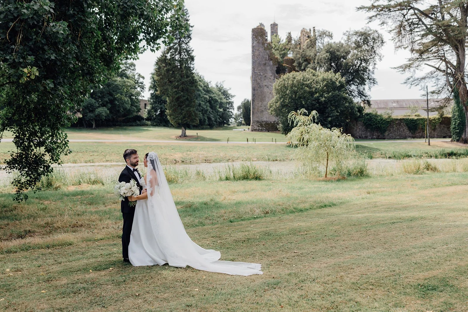 Bride and Groom with castle backdrop at Castlemartyr Resort