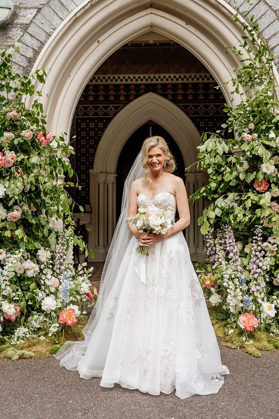 Bride by floral arch