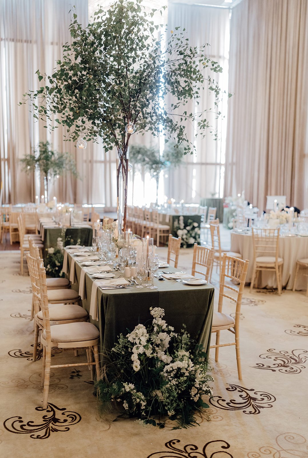 Long reception table dressed in green velvet with a tree centrepiece, styled by Amy Daunt Events at Castlemartyr Resort