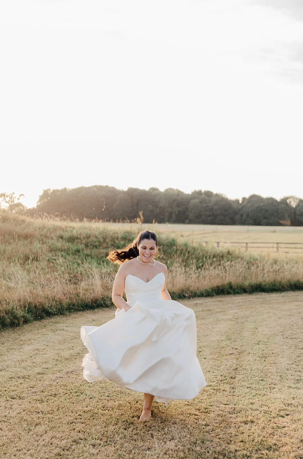Bride twirling in her wedding dress at sunset at Castlemartyr Resort, Cork