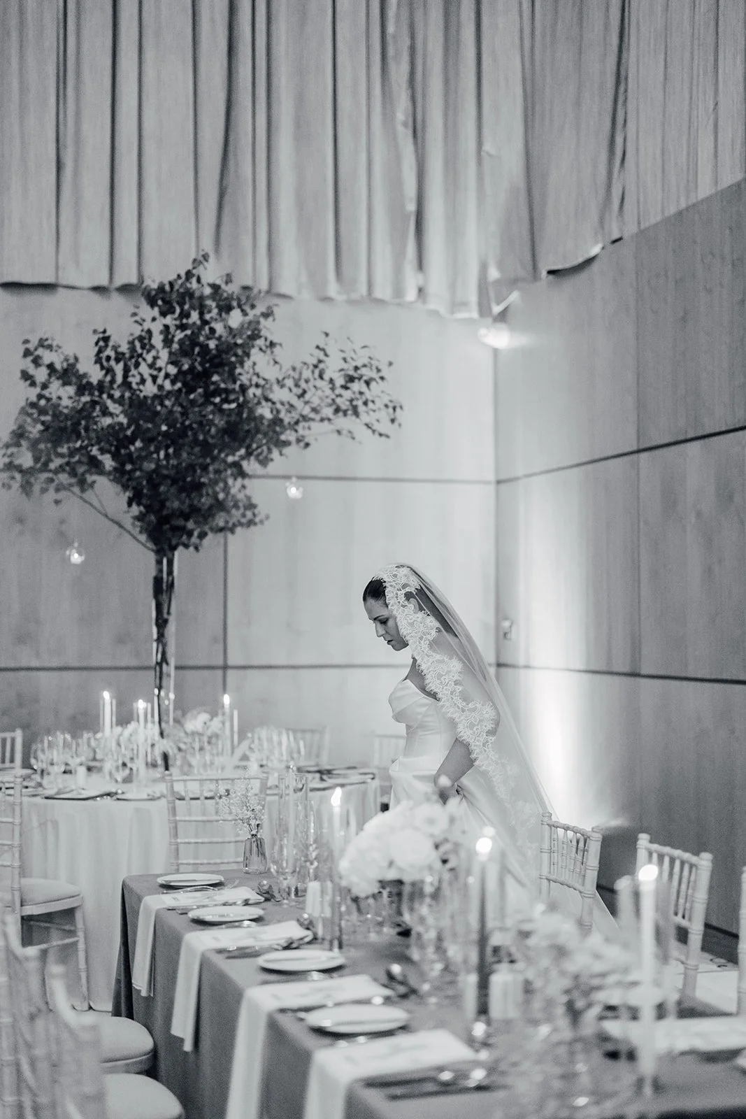 Black and white photo of the bride in her veil in the reception room at Castlemartyr