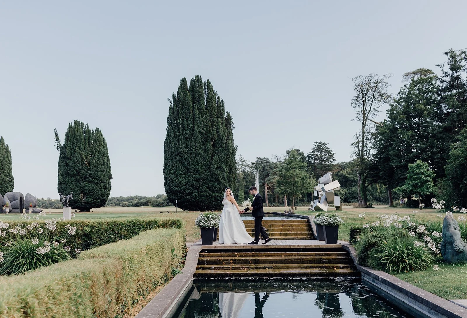 Bride and groom walking in the gardens at Castlemartyr Resort
