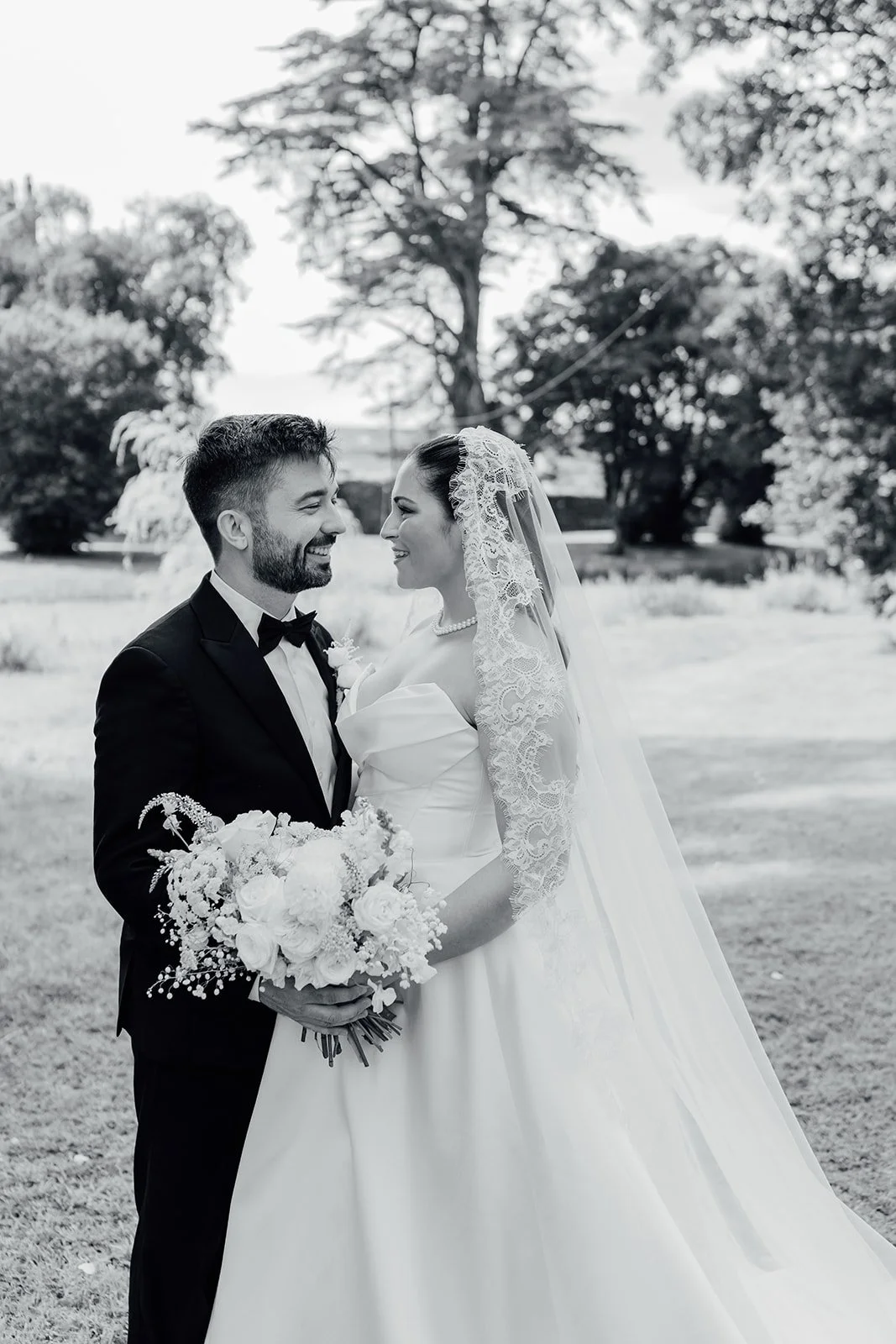 Black and white photo of the bride in the formal gardens at Castlemartyr Resort