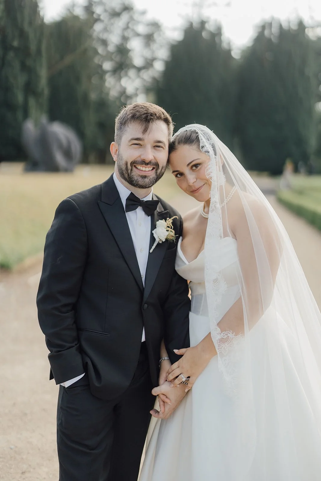 Bride and groom smiling together, bride in her long veil, at Castlemartyr Resort