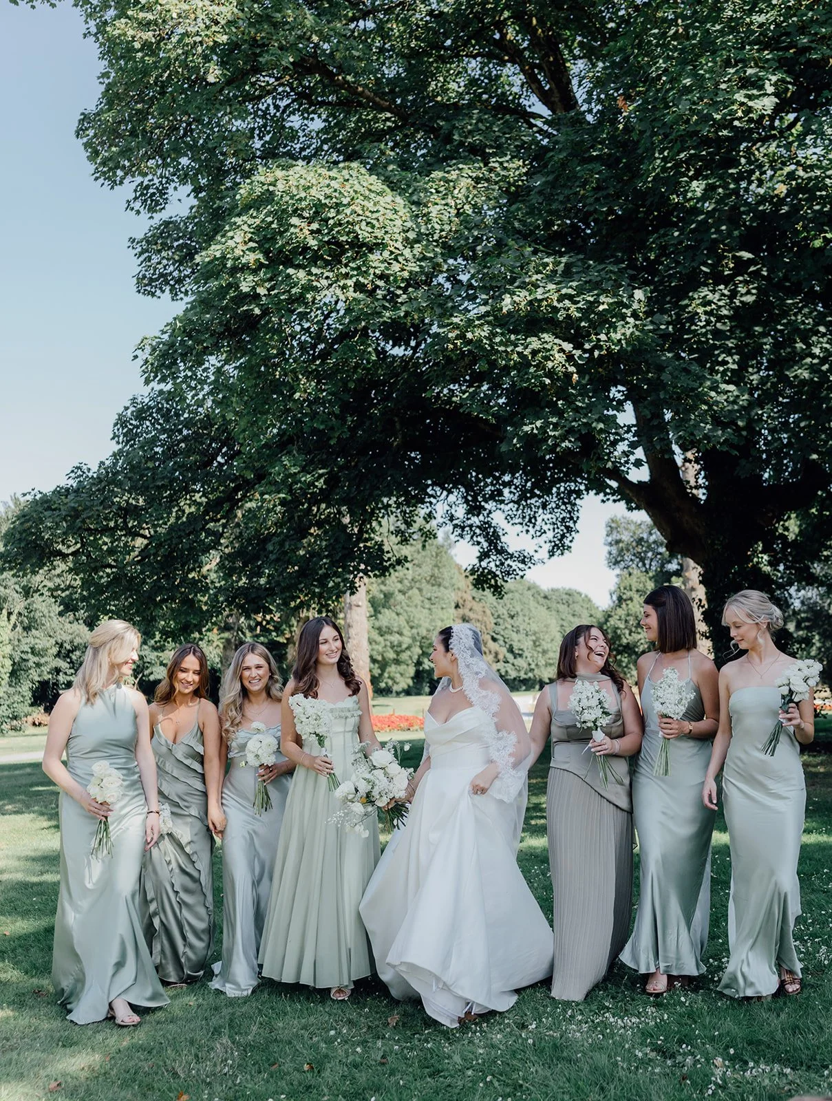 Bride with her bridesmaids under the trees at Castlemartyr Resort, Cork
