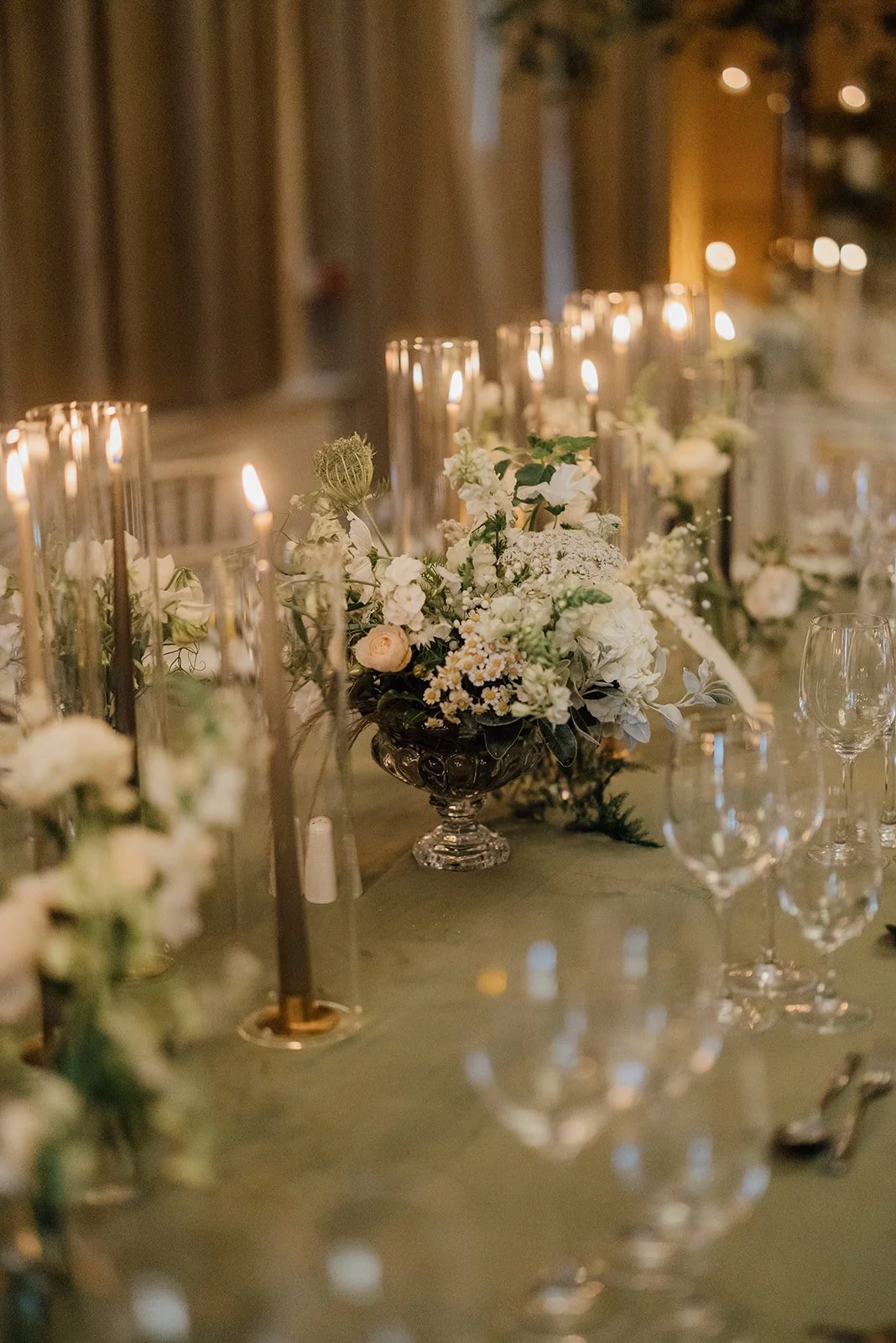Candles and white florals on a wedding reception table in East Cork
