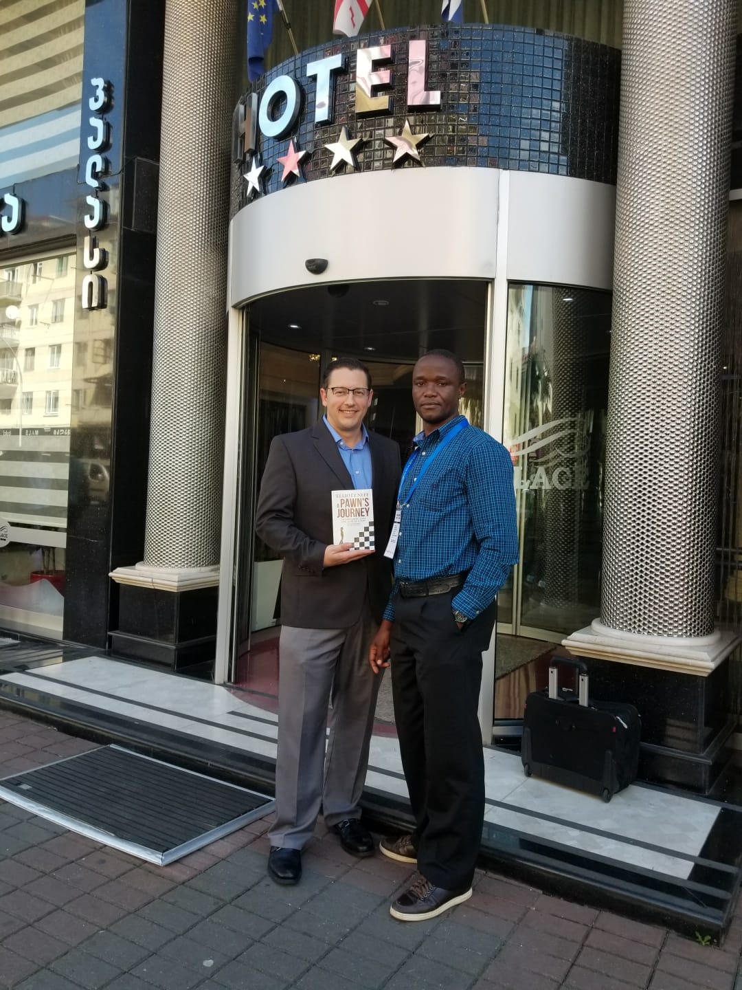 Giving Robert Katende a copy of A Pawn’s Journey