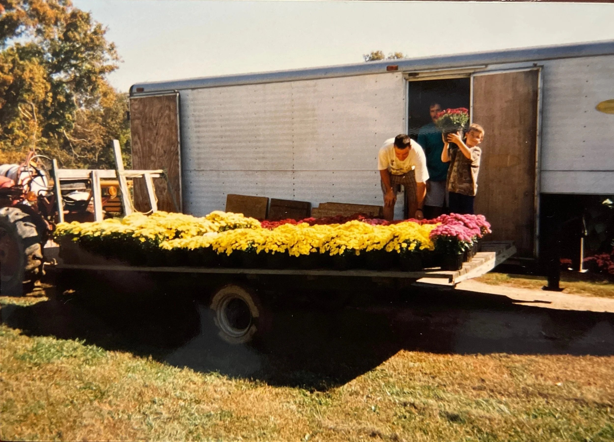 Mr. James with oldest son and staff loading mums for delivery (c. 1997)