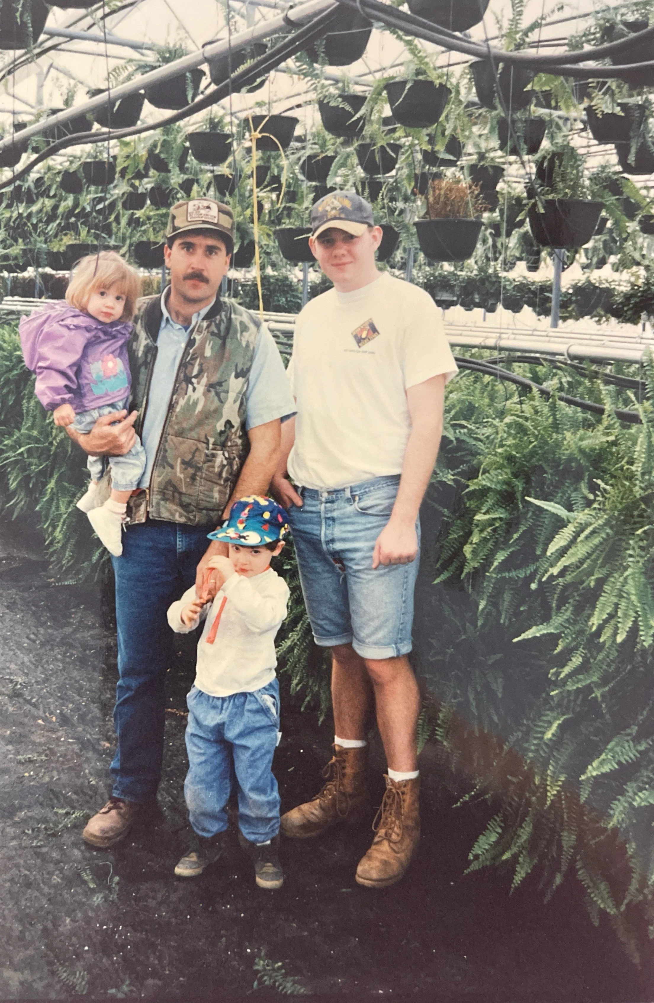 Mr. James with children at friend's fern growing operation (c. 1995)
