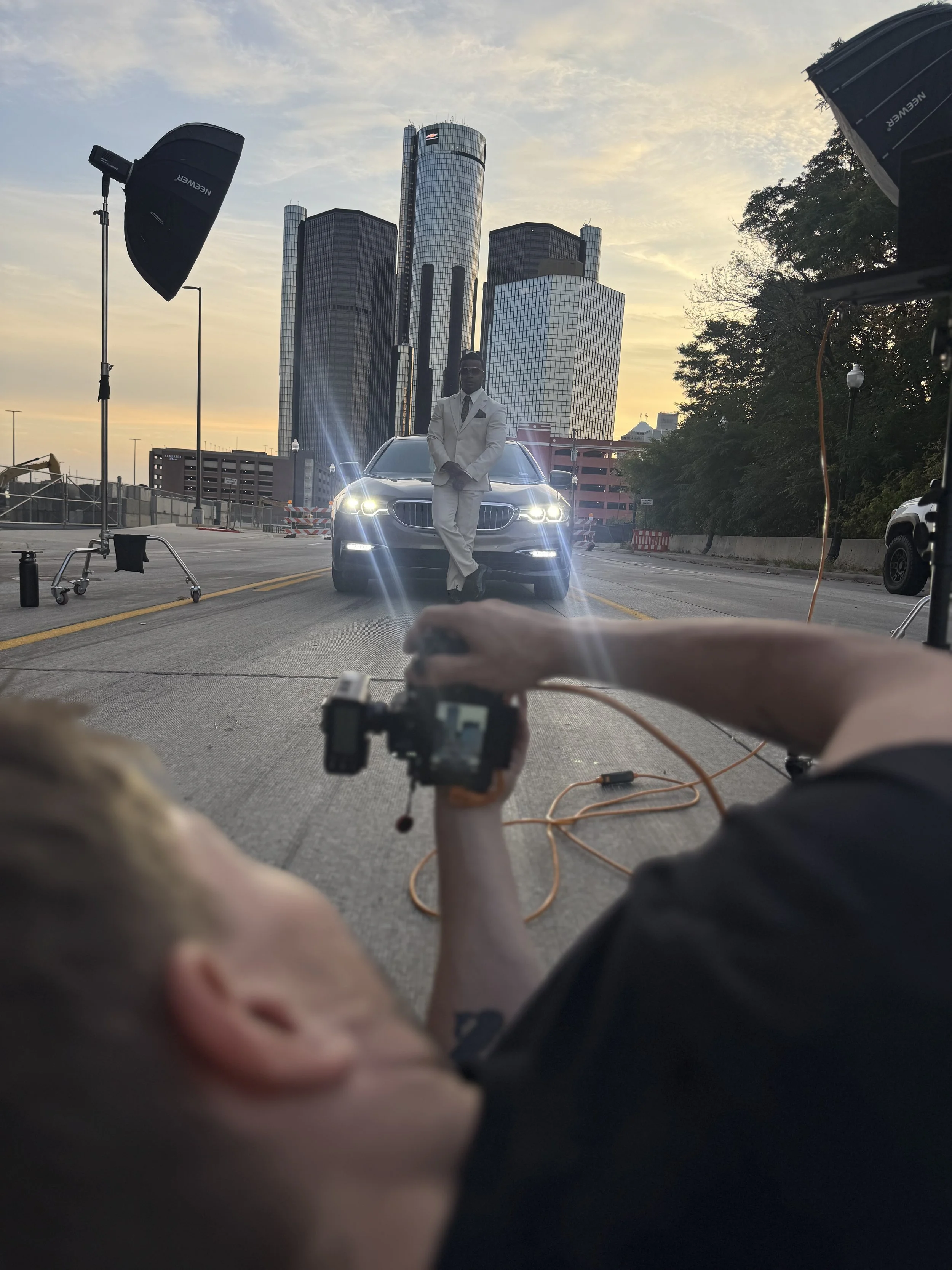 A portrait of a well-dressed man with a BMW at Detroit's Renaissance Center
