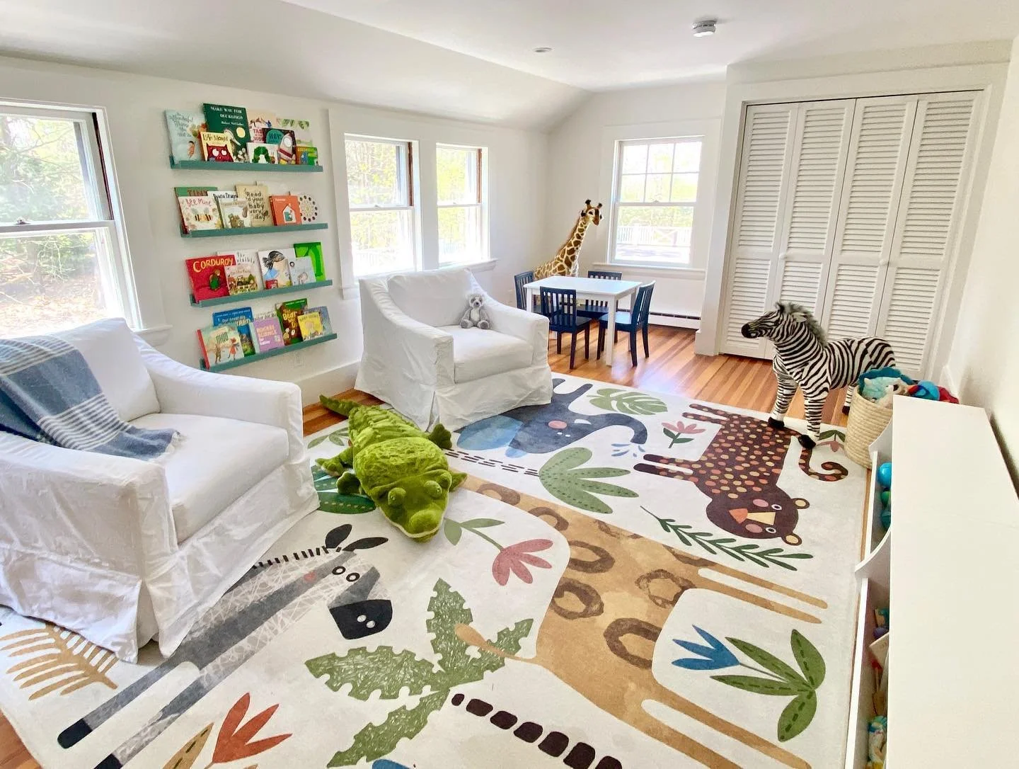 What if I told you the only thing we edited out of this space was the exercise bike? It&rsquo;s true! By adding an inviting reading zone, a craft table, and loads of kid-friendly toy storage, we took this play space from chaos to cute (and functional