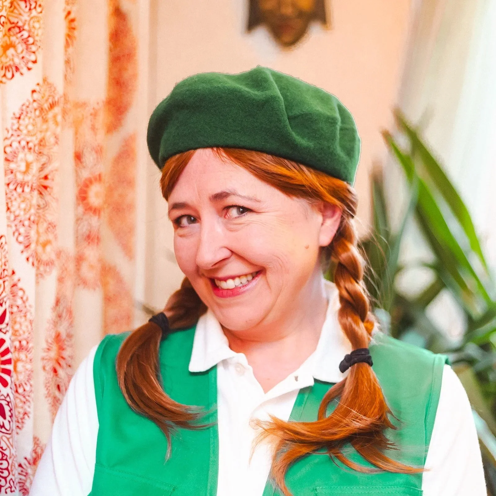 Bethany Prescott as Aspen in Close Quarters. She's smiling and in a green beret and vest with white shirt. Her hair is in two braids.