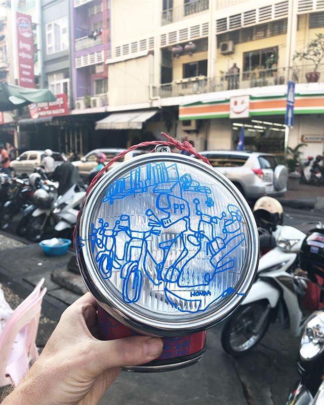 Sketch on a used motorbike headlight of some motorbikes parked on street 19 in phnom penh in cambodia. Tricky to draw around the body of the light but got some laughs from the locals when doing it (i think they thought i was a bit mad!) The red and b