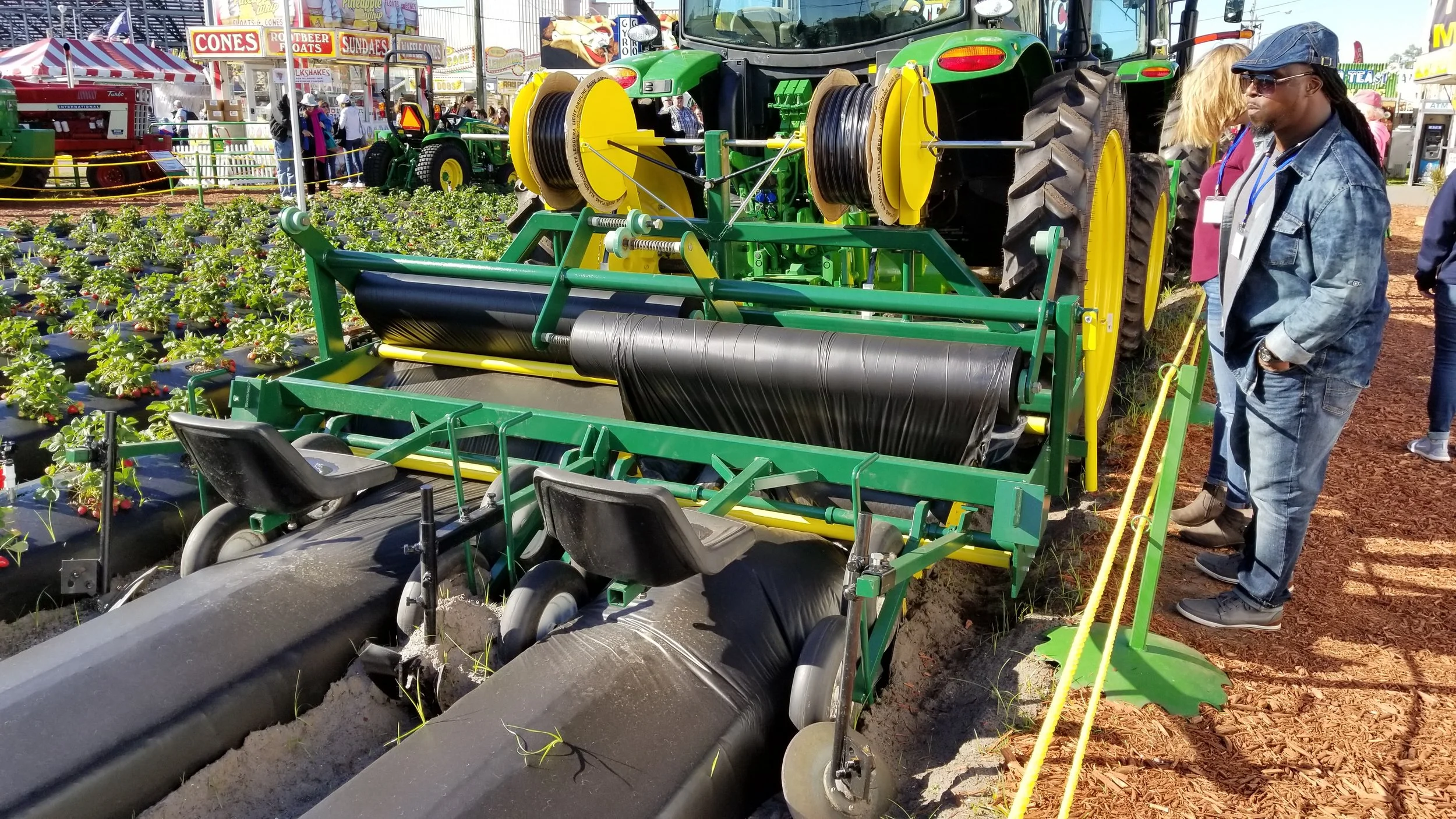 Learning about the latest in strawberry planting technology at the Strawberry Festival in Plant City, Florida