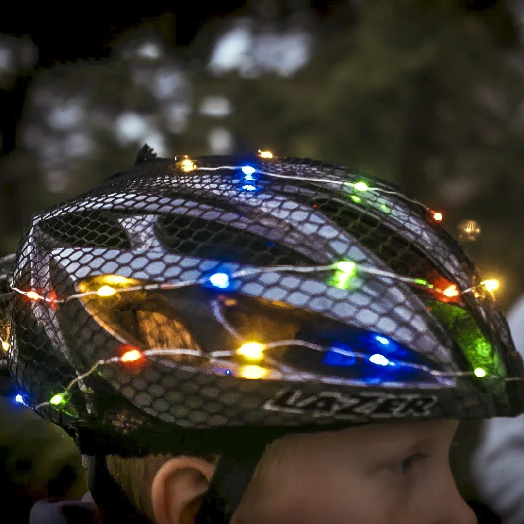 picture of someone wearing Psycholights, a mesh helmet covering embedded with colorful lights