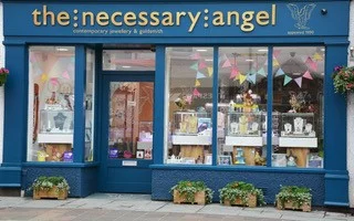 The Necessary Angel The Necessary Angel hosts a selection of stunning jewellery made by the leading designer jewellers in Britain. Also, exclusive ranges, handmade in our workshop. We aim to host a range of designs made in a variety of materials to suit all contemporary tastes and budgets. Our designer, Deborah Cowin, a master goldsmith and diamond grader, specialises in one-off original pieces and personal commissions of jewellery in platinum and 18ct gold. So if you’re looking for something new and different why not visit The Necessary Angel where you will be greeted by our friendly and knowledgeable team. 3 Tithebarn Street, Keswick, CA12 5ED