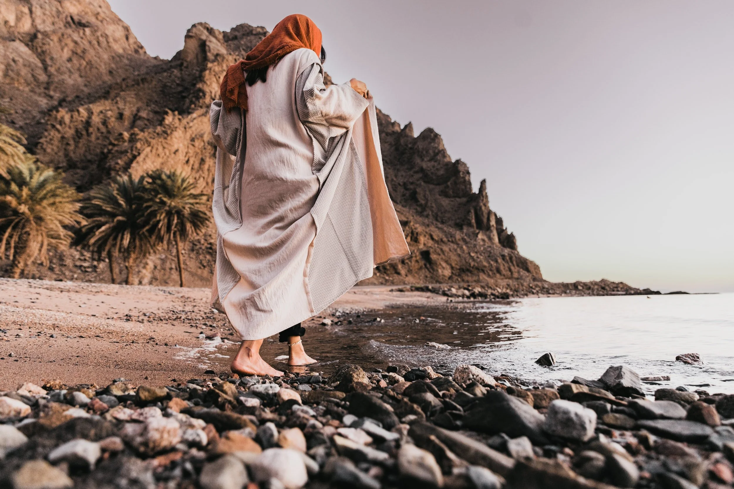 a woman walking on the beach