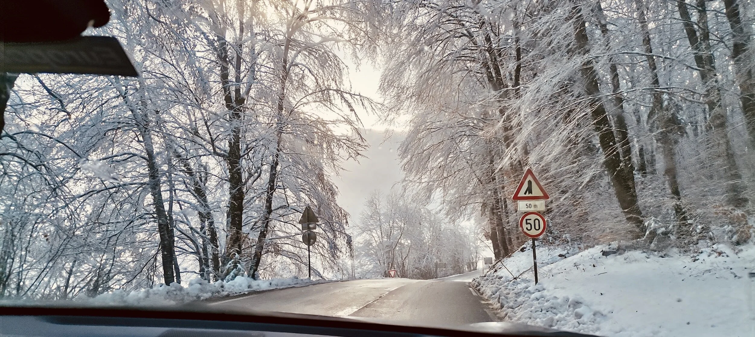 A snowy highway on a winter road trip
