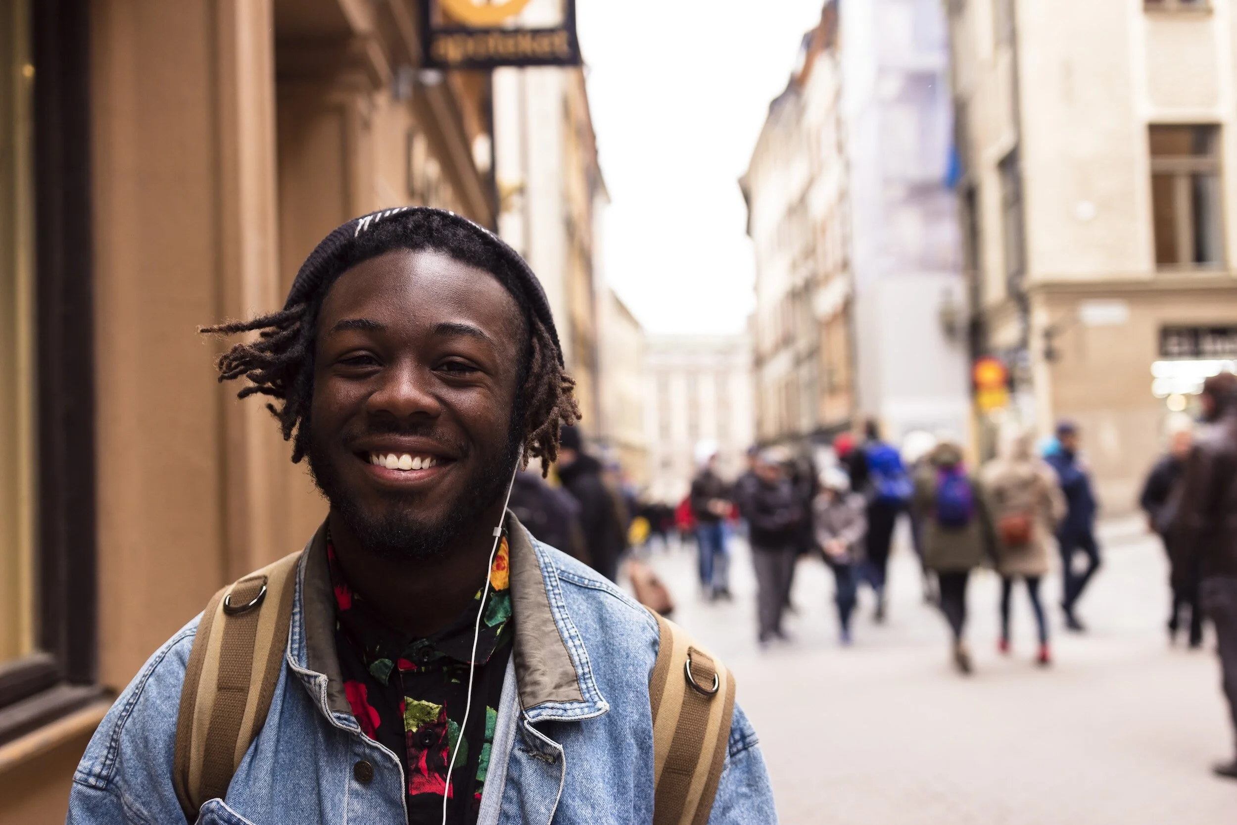 A student walking through the streets with headphones