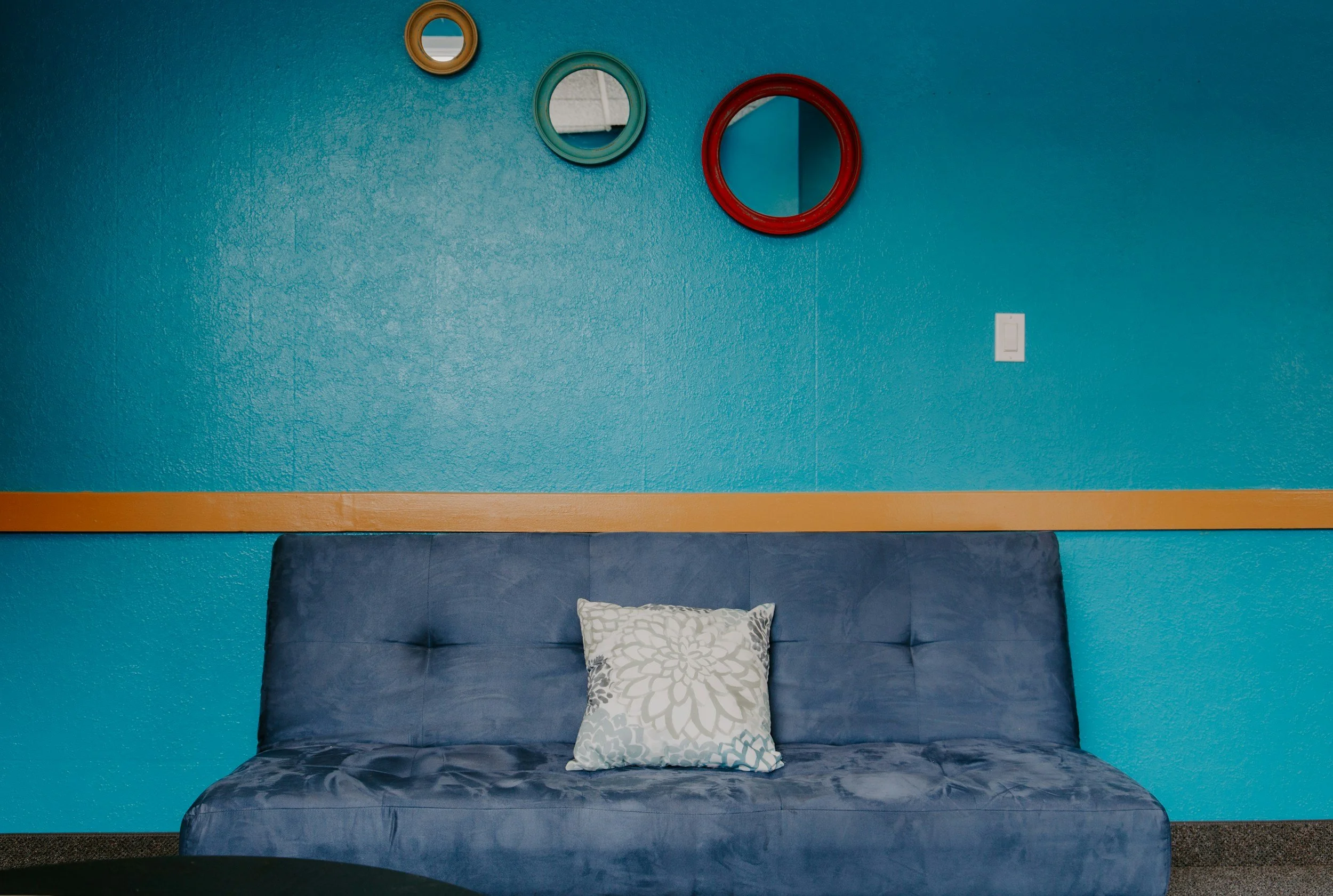 Mix and Match: Decorating Around a Blue Sofa Bed for a Balanced Look