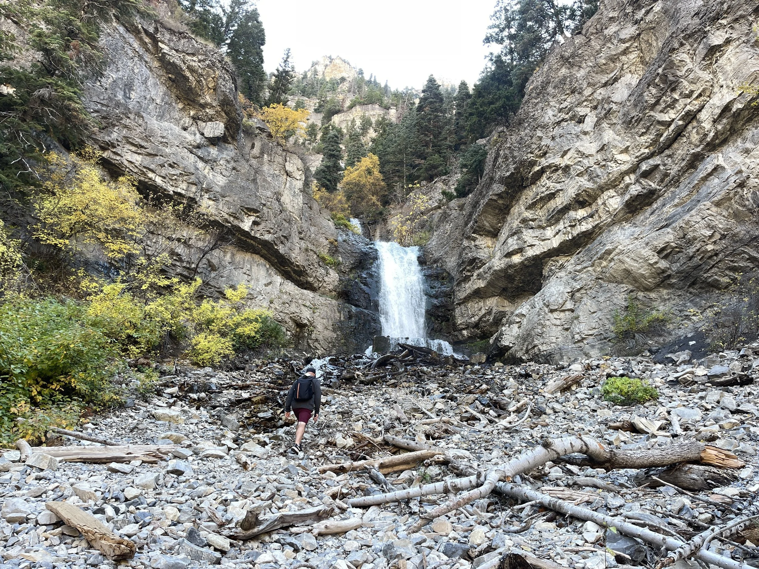 a man hiking up to Bridal Veil Falls in Utah