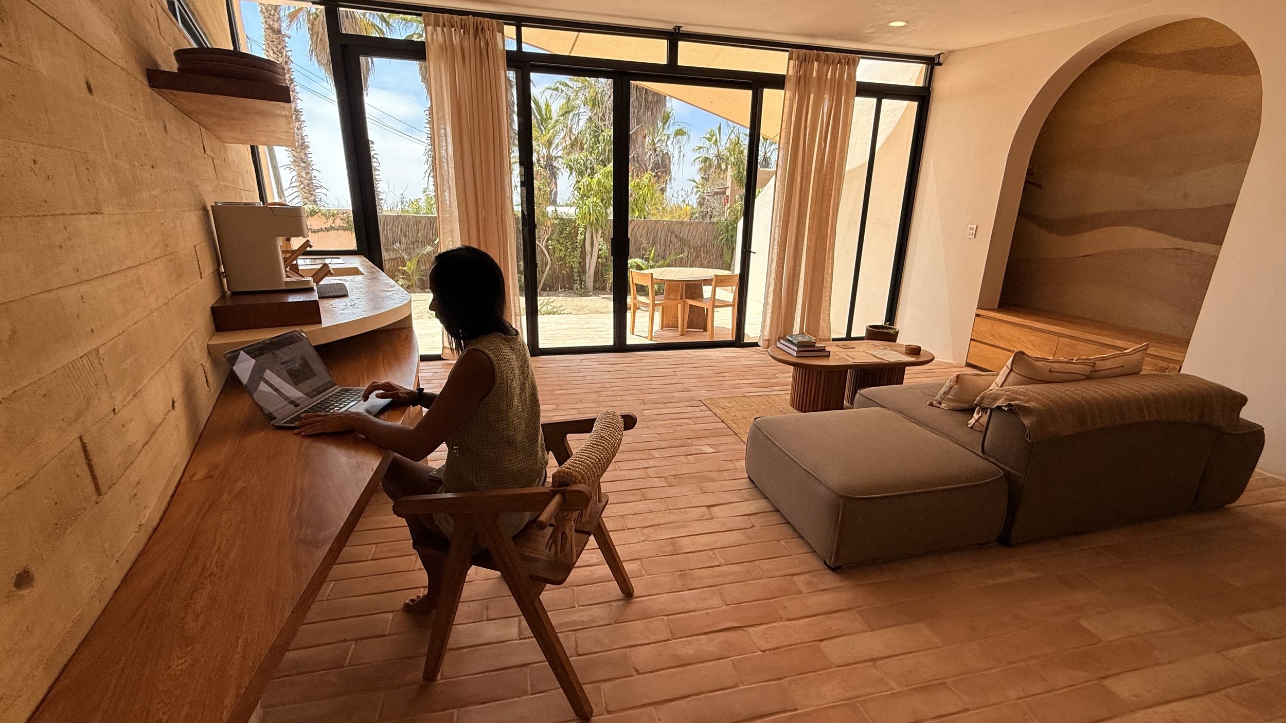 Venus sitting at a desk in a room at WAMA