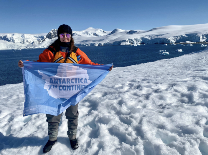 a lady holding a flag that says Antarctica