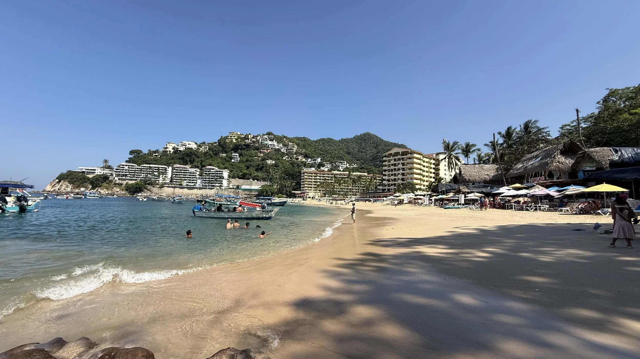 Playa Mismaloya with hotels and palapas in the background